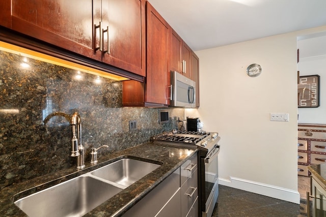 kitchen featuring dark tile patterned floors, decorative backsplash, appliances with stainless steel finishes, and dark stone counters