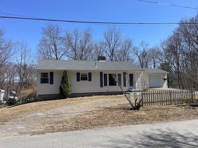ranch-style home with a garage, dirt driveway, a chimney, and fence