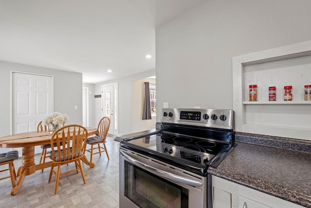 kitchen with white cabinets, stainless steel electric range, recessed lighting, and dark stone countertops