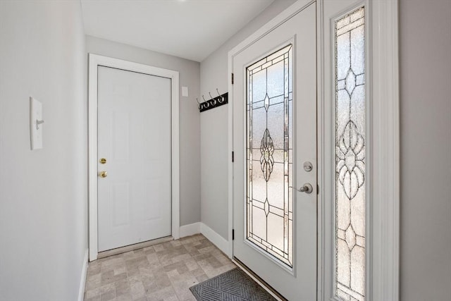 entryway featuring baseboards