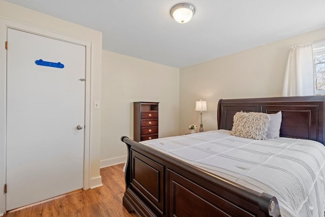 bedroom featuring light wood-style flooring and baseboards