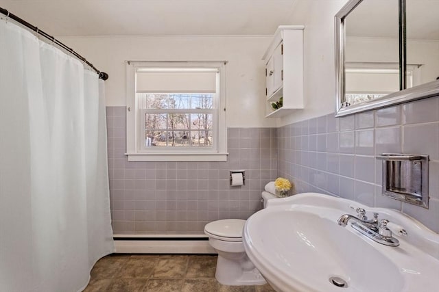 full bathroom with a sink, toilet, tile walls, a shower with shower curtain, and a baseboard radiator