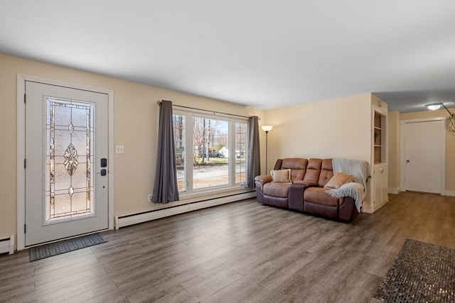 living room featuring a baseboard radiator, wood finished floors, and baseboards