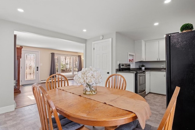 dining space with recessed lighting, baseboard heating, and light floors