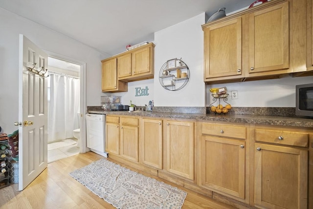 kitchen featuring white dishwasher and light hardwood / wood-style flooring