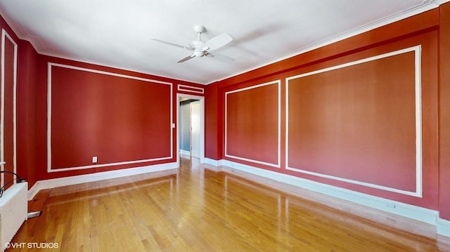 unfurnished room featuring crown molding, hardwood / wood-style flooring, radiator heating unit, and ceiling fan