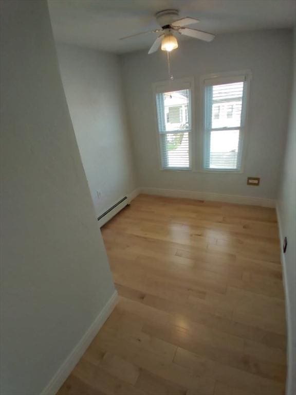 14 Russell St, Everett, MA 02149 - spare room featuring baseboard heating, light wood-type flooring, and ceiling fan