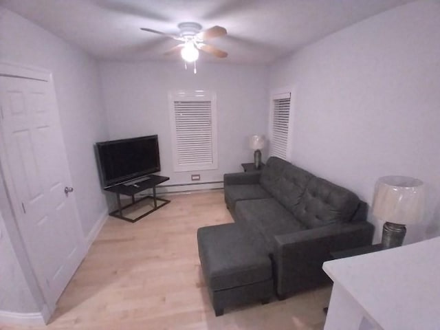 14 Russell St, Everett, MA 02149 - living room with ceiling fan, light wood-style flooring, and a baseboard radiator