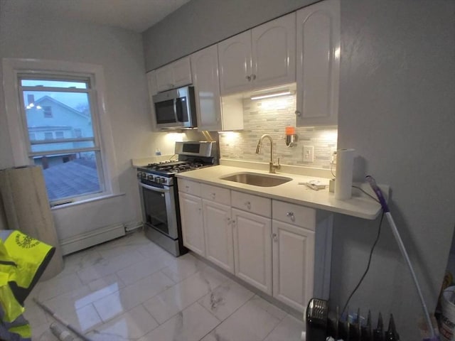 14 Russell St, Everett, MA 02149 - kitchen featuring stainless steel appliances, light marble finish flooring, white cabinets, and tasteful backsplash