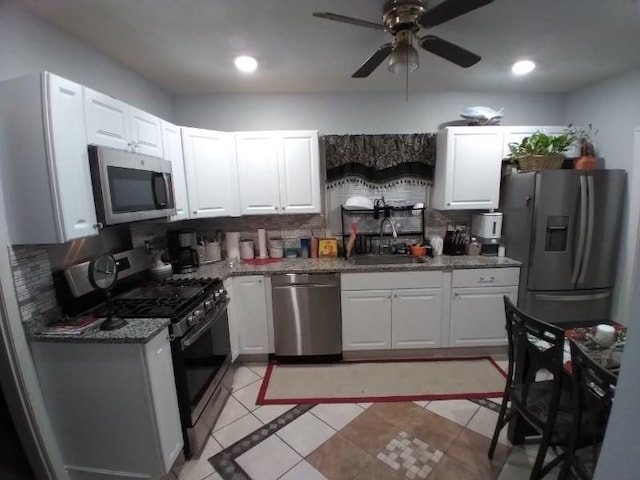 14 Russell St, Everett, MA 02149 - kitchen featuring appliances with stainless steel finishes, decorative backsplash, white cabinetry, ceiling fan, and recessed lighting