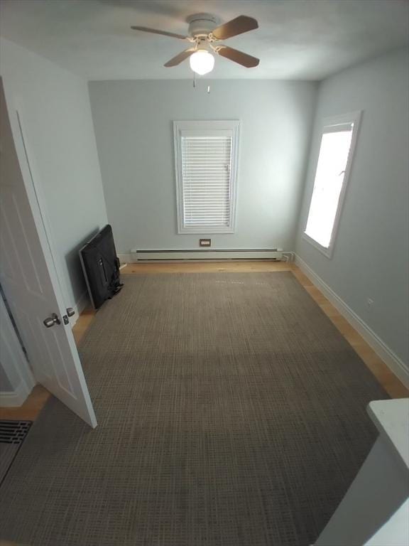 14 Russell St, Everett, MA 02149 - empty room with baseboard heating and ceiling fan
