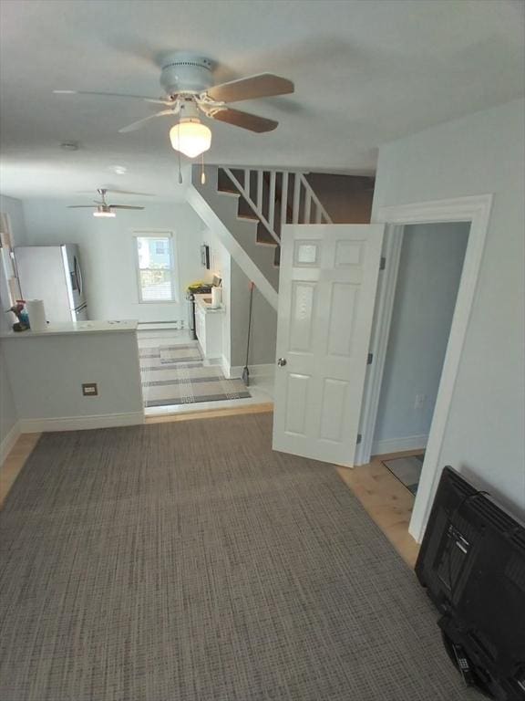14 Russell St, Everett, MA 02149 - unfurnished living room with a ceiling fan, stairway, and light colored carpet