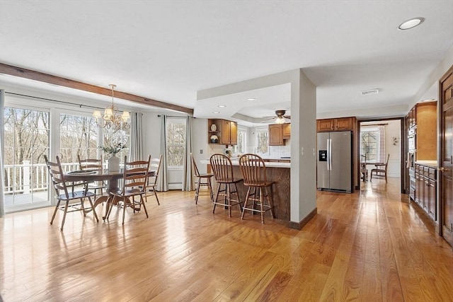 dining room featuring a chandelier, visible vents, and light wood-style flooring