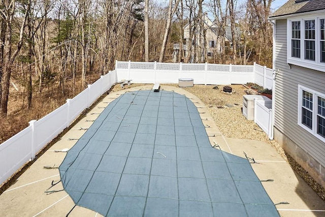 view of swimming pool featuring a fenced in pool, a patio, and a fenced backyard