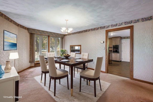 carpeted dining room with a chandelier