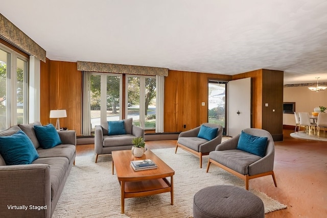 living room featuring wood walls and a wealth of natural light