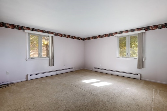 carpeted spare room featuring baseboard heating