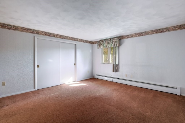 unfurnished bedroom featuring a closet, a baseboard heating unit, and carpet floors