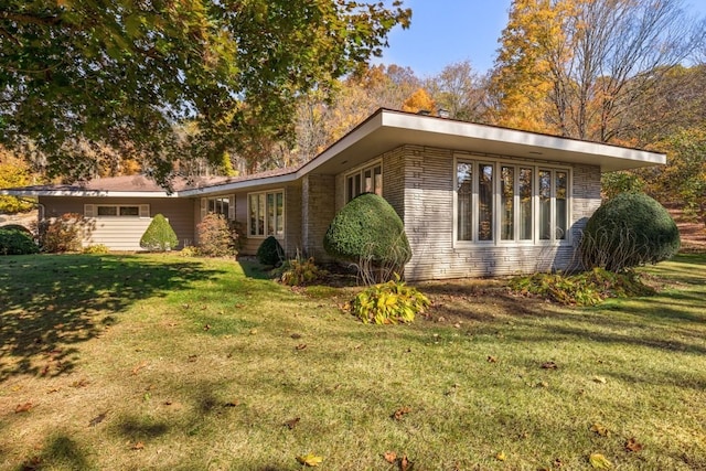 view of side of home featuring a lawn