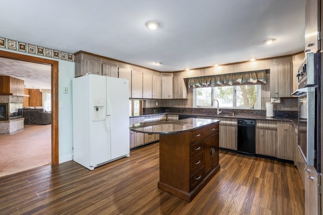 kitchen featuring a kitchen island, white refrigerator with ice dispenser, a brick fireplace, and dark hardwood / wood-style flooring