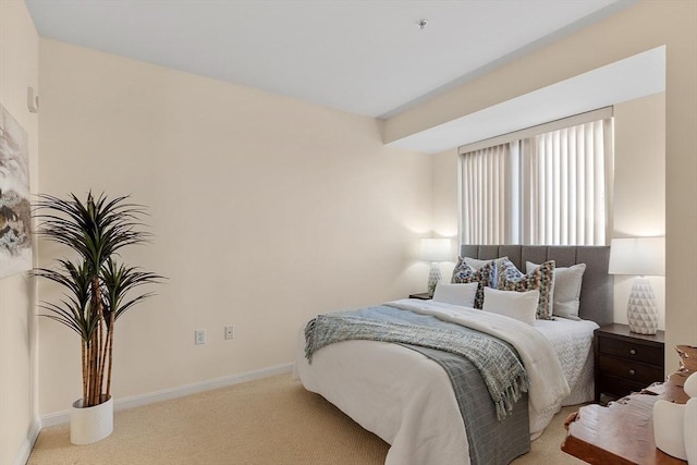 carpeted bedroom featuring baseboards