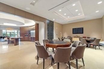 dining room featuring recessed lighting and a raised ceiling