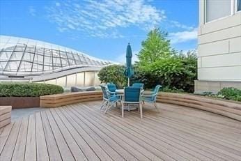 wooden deck featuring outdoor dining area