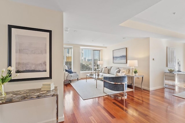 living area with wood finished floors and baseboards