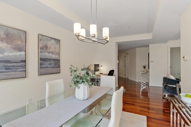 dining area with a notable chandelier, baseboards, and wood finished floors