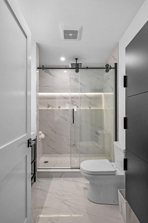 full bath featuring marble finish flooring, toilet, and a marble finish shower