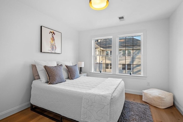 bedroom featuring multiple windows and baseboards