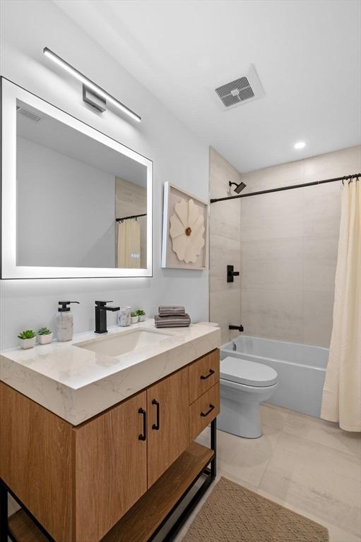 full bathroom with toilet, vanity, and shower / tub combo with curtain