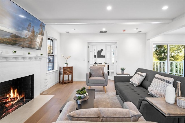 living area featuring a fireplace, wood finished floors, recessed lighting, and baseboards