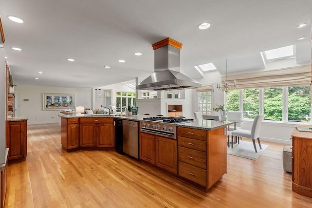 8 Pleasant St, Dover, MA 02030 - kitchen featuring a skylight, island range hood, stovetop, light wood-type flooring, and recessed lighting