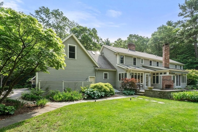8 Pleasant St, Dover, MA 02030 - rear view of house with a chimney, a lawn, a sunroom, and roof with shingles