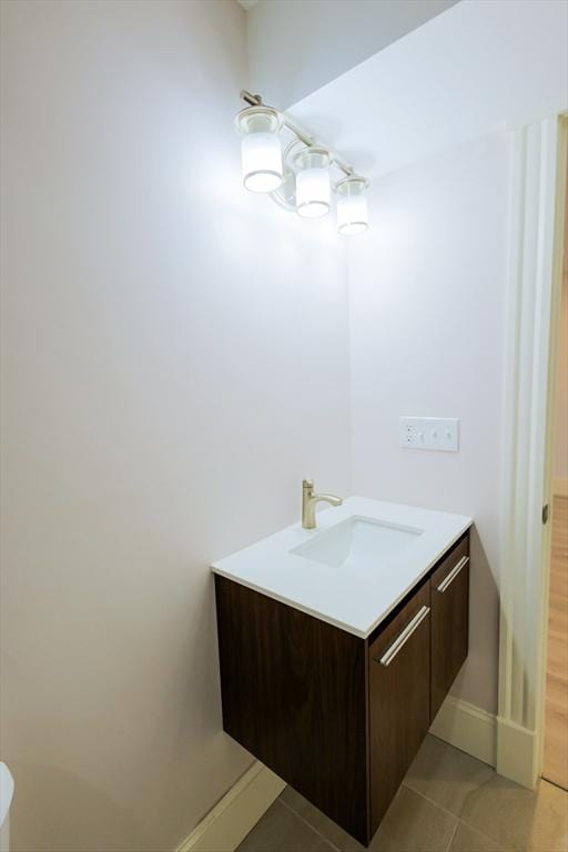 bathroom featuring tile patterned floors, vanity, and baseboards