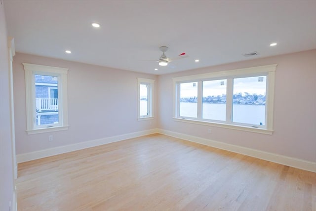 spare room with recessed lighting, ceiling fan, light wood-style flooring, and baseboards