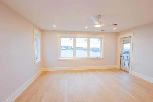 spare room with recessed lighting, a ceiling fan, light wood finished floors, and baseboards