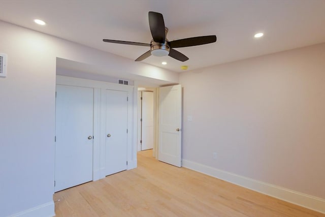 unfurnished bedroom with visible vents, light wood-style floors, and recessed lighting