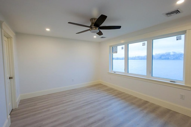 unfurnished room with visible vents, light wood finished floors, and recessed lighting