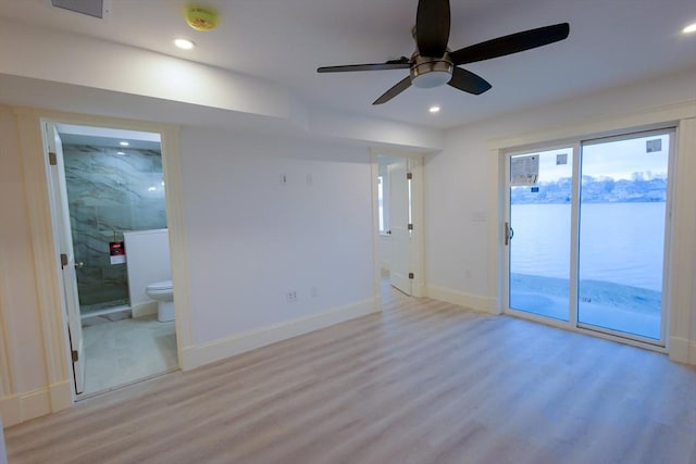 spare room featuring recessed lighting, a ceiling fan, baseboards, and light wood-style floors