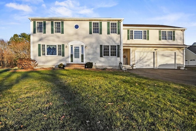 view of front of house with a garage and a front yard