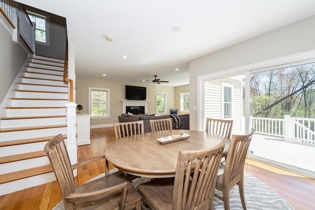 70 Rockland St, Natick, MA 01760 - dining area with a ceiling fan, a fireplace, stairway, recessed lighting, and light wood-style flooring