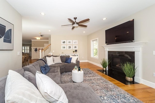 70 Rockland St, Natick, MA 01760 - living room with a ceiling fan, baseboards, a fireplace with flush hearth, wood finished floors, and stairway