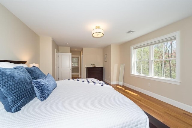 70 Rockland St, Natick, MA 01760 - bedroom with baseboards, wood finished floors, and visible vents