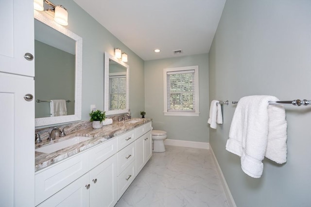 70 Rockland St, Natick, MA 01760 - bathroom featuring a sink, visible vents, double vanity, and marble finish floor