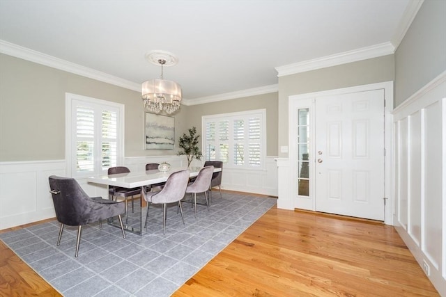 70 Rockland St, Natick, MA 01760 - dining area with ornamental molding, light wood finished floors, a notable chandelier, and a wealth of natural light