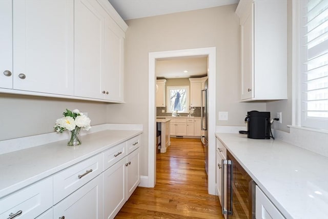 70 Rockland St, Natick, MA 01760 - kitchen with white cabinetry, a healthy amount of sunlight, and light wood-style floors