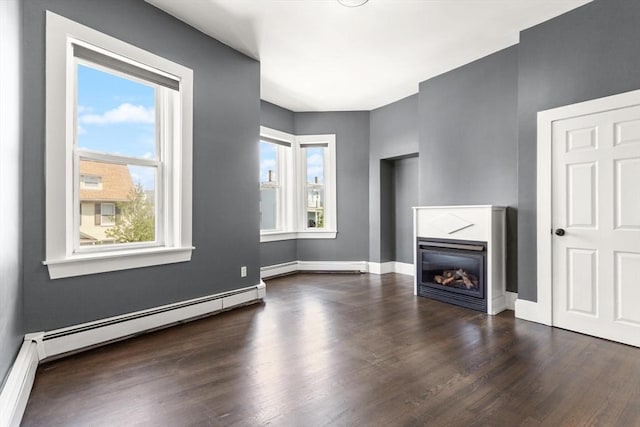 17 Savin Hill Ave Unit 3, Boston, MA 02125 - unfurnished living room featuring wood finished floors, a glass covered fireplace, and a baseboard radiator