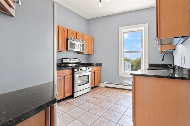 17 Savin Hill Ave Unit 3, Boston, MA 02125 - kitchen featuring appliances with stainless steel finishes, baseboard heating, light tile patterned floors, and dark stone countertops